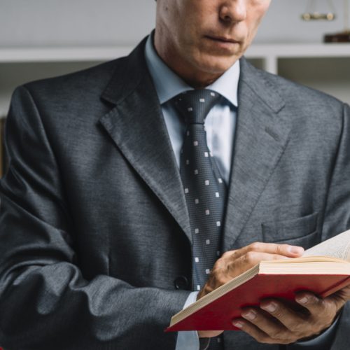 close-up-of-lawyer-reading-book-in-the-courtroom